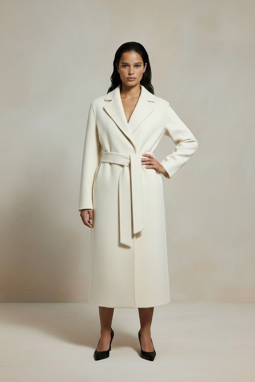 Refined Elegance cream cashmere blend wrap coat with a belted waist, sharp lapels, and long silhouette on a model.
