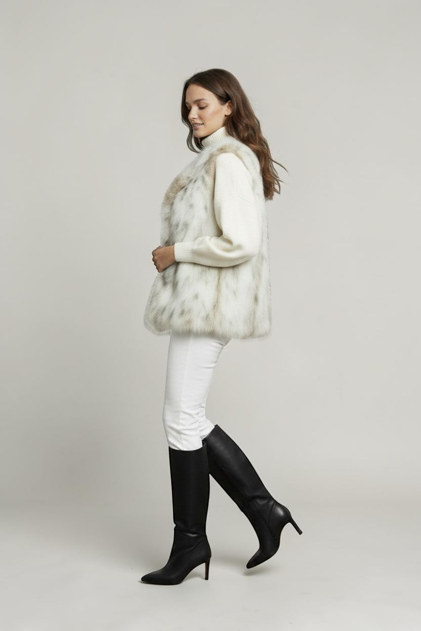Refined Elegance sleeveless faux fur vest in cream and taupe worn by a model with a white sweater and black boots
