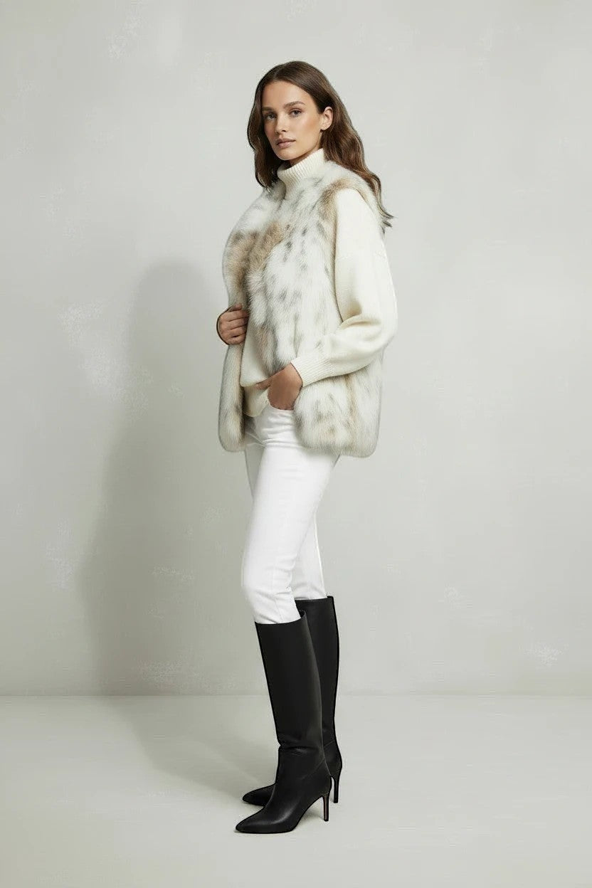 Refined Elegance cream and taupe mottled faux fur vest worn by a model over a white sweater and trousers